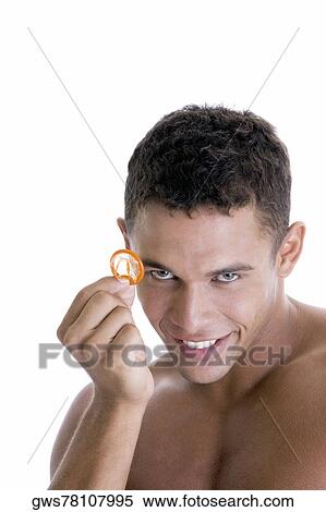 Portrait of a young man holding a condom View Large Photo Image Stock Photography - Portrait of a young man holding a condom. Fotosearch