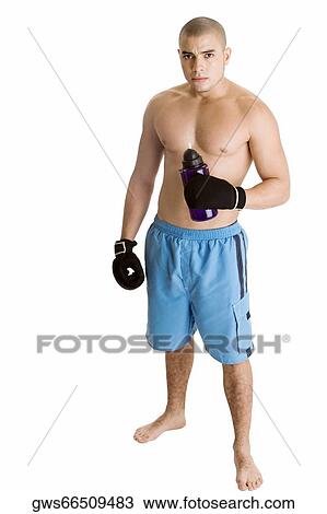 Stock Image - Portrait of a young man holding a water bottle. Fotosearch