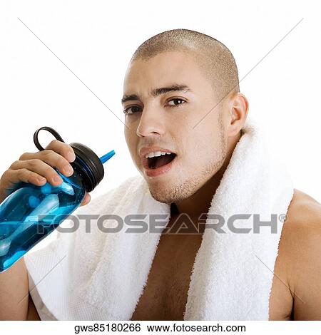 Portrait of a young man holding a water bottle View Large Photo Image Stock Photograph - Portrait of a young man holding a water bottle. Fotosearch