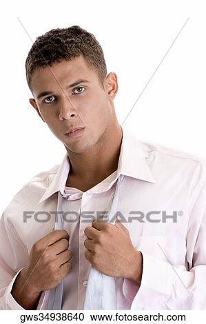 Portrait of a young man holding his tie View Large Photo Image Stock Image - Portrait of a young man holding his tie. Fotosearch