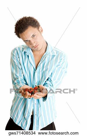 Portrait of a young man holding strawberries View Large Photo Image Picture - Portrait of a young man holding strawberries. Fotosearch
