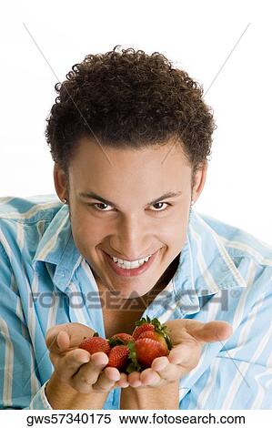 Portrait of a young man holding strawberries View Large Photo Image Stock Photography - Portrait of a young man holding strawberries. Fotosearch