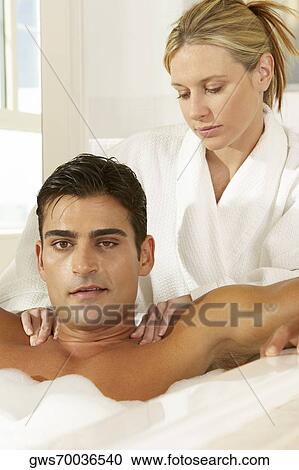 Portrait of a young man in a bubble bath receiving a massage View Large Photo Image Stock Image - Portrait of a young man in a bubble bath receiving a massage. Fotosearch