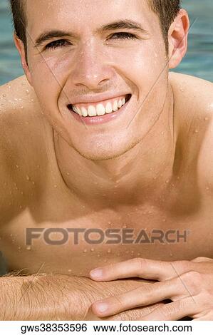Portrait of a young man in a swimming pool View Large Photo Image Stock Photograph - Portrait of a young man in a swimming pool. Fotosearch