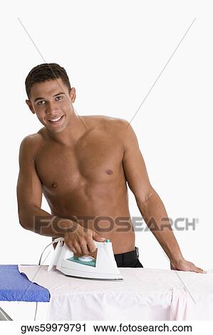Portrait of a young man ironing clothes View Large Photo Image Stock Image - Portrait of a young man ironing clothes. Fotosearch