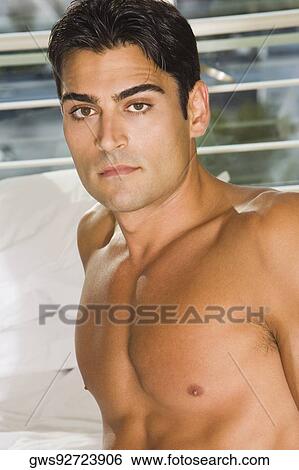 Portrait of a young man looking serious View Large Photo Image Stock Photograph - Portrait of a young man looking serious. Fotosearch