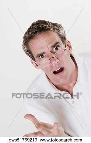 Portrait of a young man looking shocked View Large Photo Image Stock Photo - Portrait of a young man looking shocked. Fotosearch