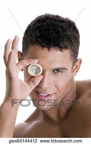Portrait of a young man looking through a condom View Large Photo Image Stock Image - Portrait of a young man looking through a condom. Fotosearch