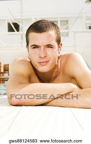 Portrait of a young man lying at the poolside View Large Photo Image Stock Image - Portrait of a young man lying at the poolside. Fotosearch