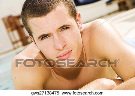 Portrait of a young man lying at the poolside View Large Photo Image Stock Photography - Portrait of a young man lying at the poolside. Fotosearch