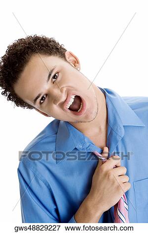 Portrait of a young man making a face View Large Photo Image Stock Photo - Portrait of a young man making a face. Fotosearch