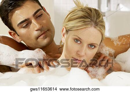 Portrait of a young man massaging a young woman in a bathtub View Large Photo Image Picture - Portrait of a young man massaging a young woman in a bathtub. Fotosearch