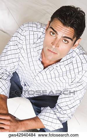 Picture - Portrait of a young man sitting. Fotosearch