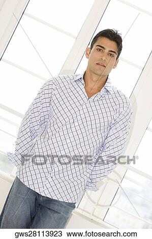 Stock Image - Portrait of a young man standing. Fotosearch