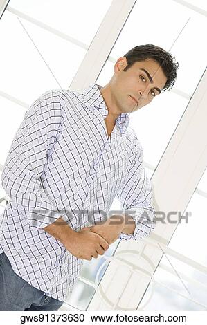 Stock Image - Portrait of a young man standing. Fotosearch
