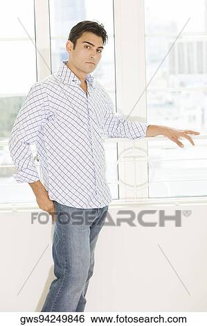 Stock Photograph - Portrait of a young man standing. Fotosearch