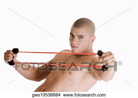 Portrait of a young man stretching a resistance band View Large Photo Image Picture - Portrait of a young man stretching a resistance band. Fotosearch