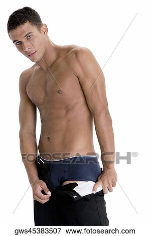 Portrait of a young man taking off his pants View Large Photo Image Stock Photo - Portrait of a young man taking off his pants. Fotosearch