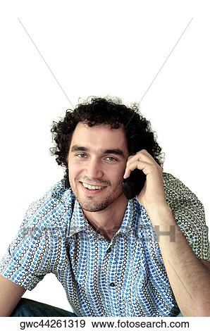 Portrait of a young man talking on a mobile phone View Large Photo Image Stock Photo - Portrait of a young man talking on a mobile phone. Fotosearch