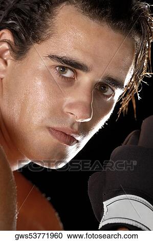 Portrait of a young man wearing boxing gloves View Large Photo Image Stock Image - Portrait of a young man wearing boxing gloves. Fotosearch