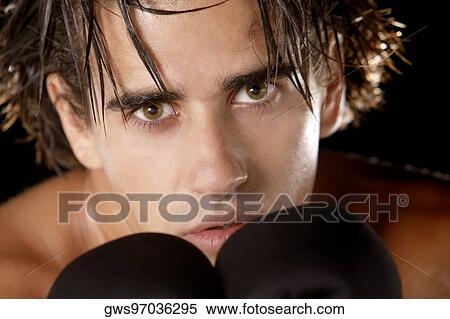Portrait of a young man wearing boxing gloves View Large Photo Image Stock Photography - Portrait of a young man wearing boxing gloves. Fotosearch