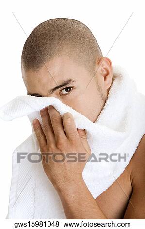 Portrait of a young man wiping his face with a towel View Large Photo Image Stock Photo - Portrait of a young man wiping his face with a towel. Fotosearch