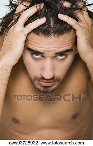 Portrait of a young man with his hands on his head View Large Photo Image Stock Image - Portrait of a young man with his hands on his head. Fotosearch