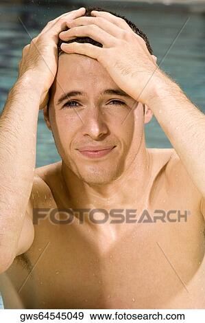 Portrait of a young man with his hands on his head View Large Photo Image Stock Photo - Portrait of a young man with his hands on his head. Fotosearch