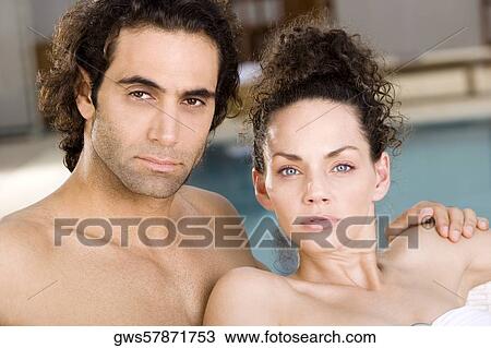 Portrait of a young woman and a mid adult man at the poolside View Large Photo Image Stock Image - Portrait of a young woman and a mid adult man at the poolside. Fotosearch