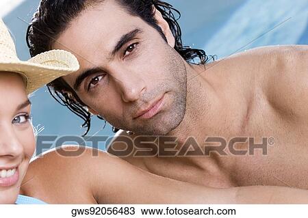 Portrait of a young woman and a mid adult man smiling View Large Photo Image Stock Image - Portrait of a young woman and a mid adult man smiling. Fotosearch