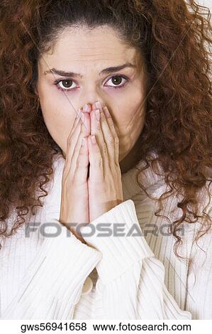 Portrait of a young woman covering her face with her hands View Large Photo Image Stock Photo - Portrait of a young woman covering her face with her hands. Fotosearch