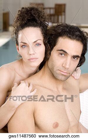 Portrait of a young woman embracing a mid adult man from behind View Large Photo Image Stock Image - Portrait of a young woman embracing a mid adult man from behind. Fotosearch