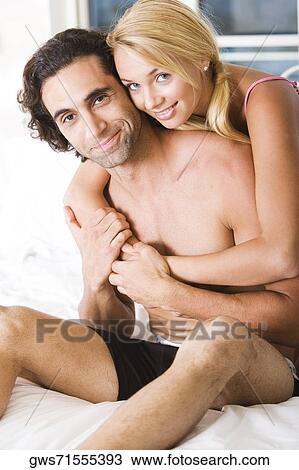 Portrait of a young woman embracing a young man from behind View Large Photo Image Stock Image - Portrait of a young woman embracing a young man from behind. Fotosearch