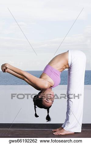 Portrait of a young woman exercising View Large Photo Image Stock Image - Portrait of a young woman exercising. Fotosearch