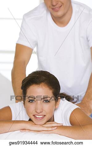Portrait of a young woman getting a shoulder massage View Large Photo Image Picture - Portrait of a young woman getting a shoulder massage. Fotosearch