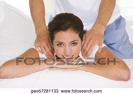 Portrait of a young woman getting a shoulder massage View Large Photo Image Stock Image - Portrait of a young woman getting a shoulder massage. Fotosearch