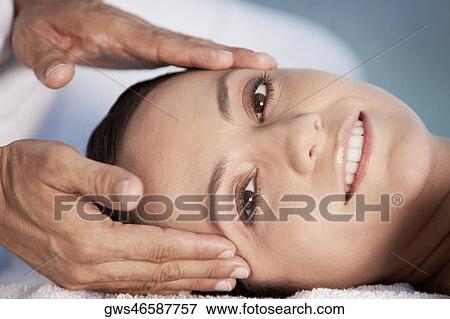 Portrait of a young woman getting a head massage View Large Photo Image Stock Photo - Portrait of a young woman getting a head massage. Fotosearch