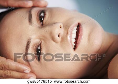 Portrait of a young woman getting a head massage View Large Photo Image Stock Photography - Portrait of a young woman getting a head massage. Fotosearch