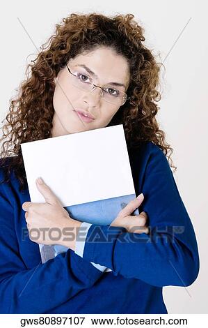 Stock Photo - Portrait of a young woman holding a file. Fotosearch