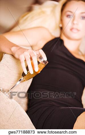 Portrait of a young woman holding a glass of wine View Large Photo Image Stock Image - Portrait of a young woman holding a glass of wine. Fotosearch