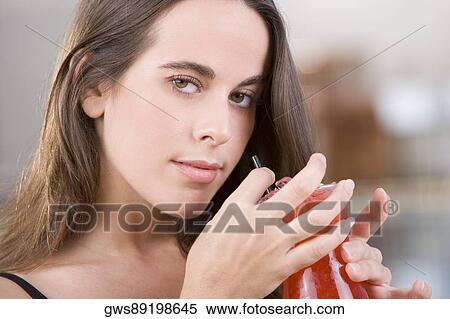 Stock Photography - Portrait of a young woman holding a cocktail. Fotosearch