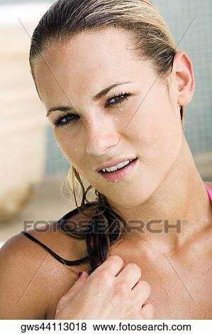 Portrait of a young woman holding her wet hair View Large Photo Image Stock Photo - Portrait of a young woman holding her wet hair. Fotosearch