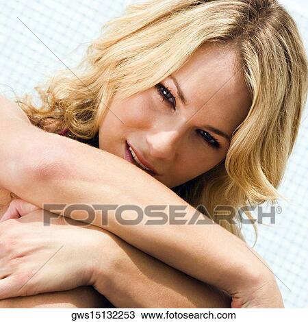 Portrait of a young woman hugging her knees View Large Photo Image Stock Image - Portrait of a young woman hugging her knees. Fotosearch