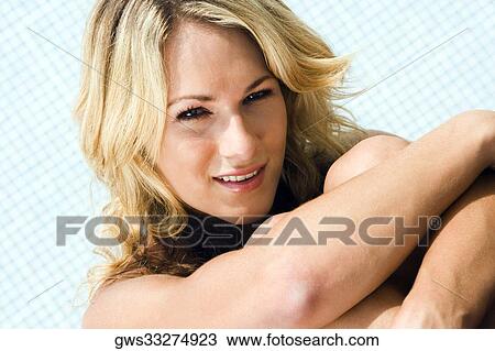 Portrait of a young woman hugging her knees View Large Photo Image Stock Image - Portrait of a young woman hugging her knees. Fotosearch