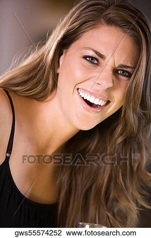 Stock Image - Portrait of a young woman laughing. Fotosearch