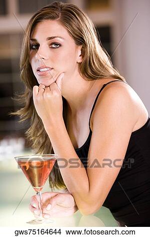 Portrait of a young woman leaning over a bar counter View Large Photo Image Picture - Portrait of a young woman leaning over a bar counter. Fotosearch
