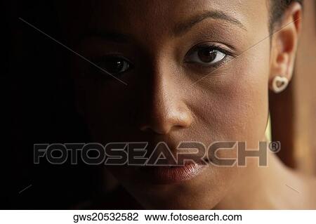 Portrait of a young woman looking serious View Large Photo Image Stock Image - Portrait of a young woman looking serious. Fotosearch