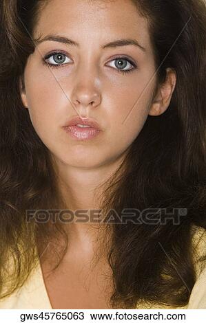 Portrait of a young woman looking serious View Large Photo Image Stock Image - Portrait of a young woman looking serious. Fotosearch