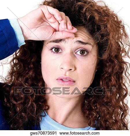 Stock Image - Portrait of a young woman looking worried. Fotosearch