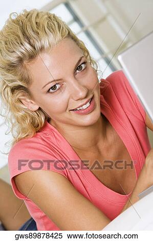Portrait of a young woman lying in front of a laptop View Large Photo Image Stock Photography - Portrait of a young woman lying in front of a laptop. Fotosearch